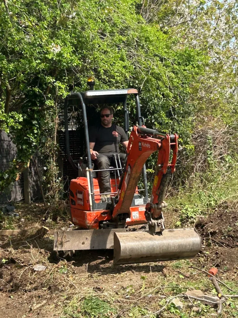 Mini excavator carrying out commercial site clearance and ground preparation by Red Fox Tree Care in the North East.